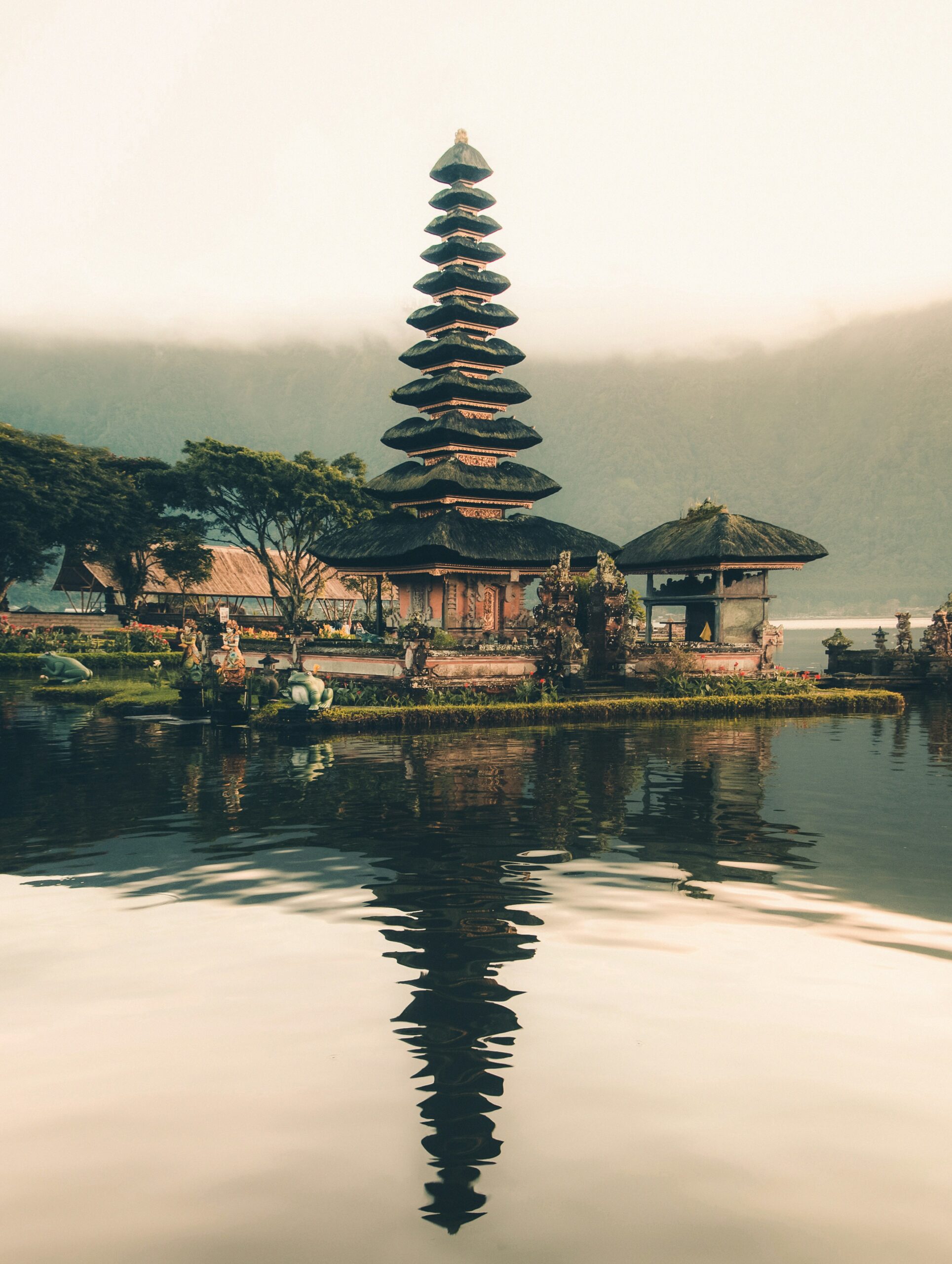 Temple beside body of water and trees