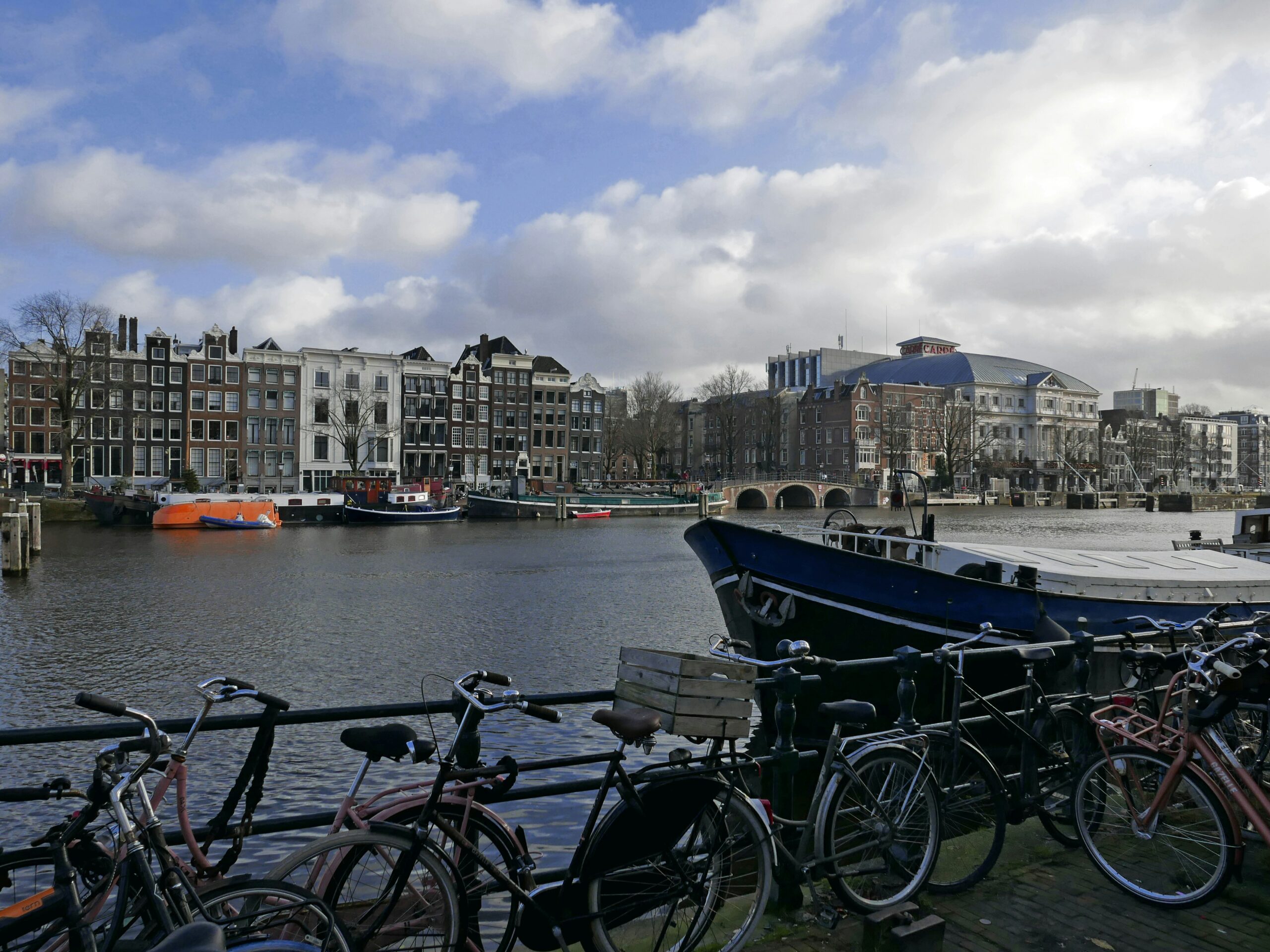 A row of bikes parked next to a body of water