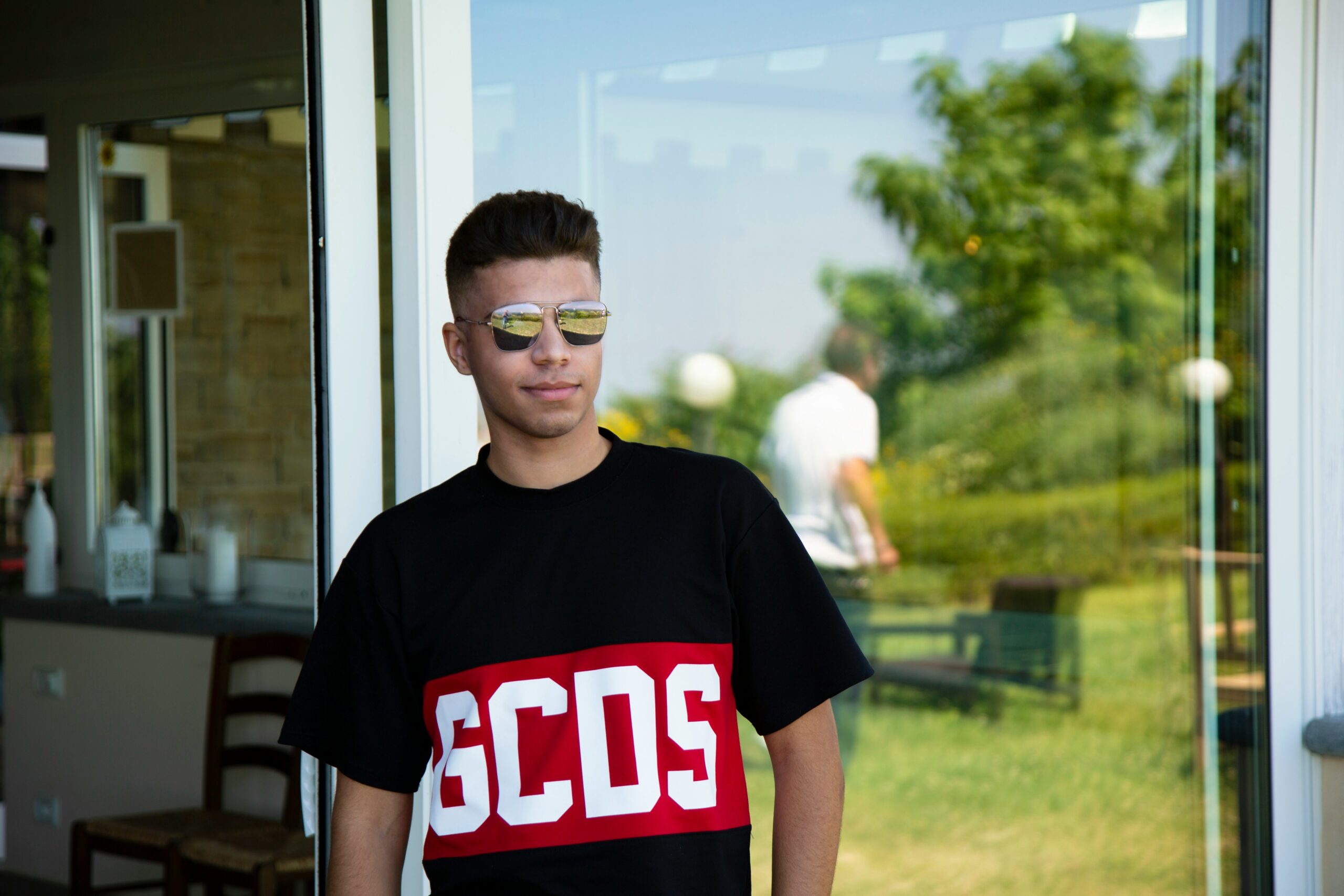 Boy in black crew neck t-shirt wearing black framed eyeglasses