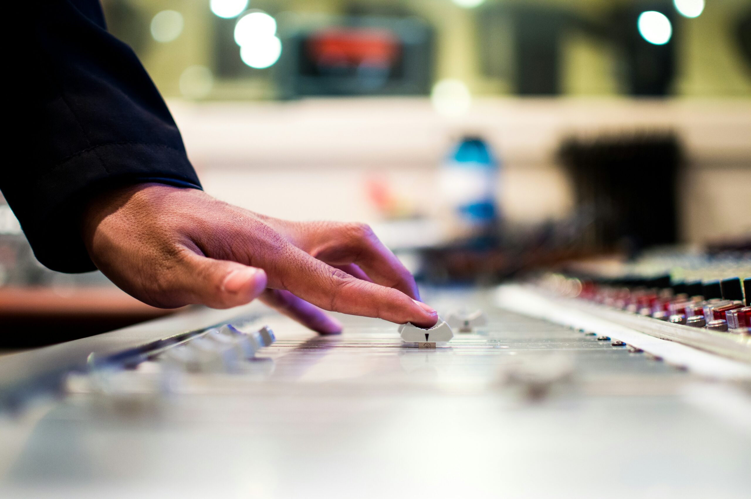 Person holding mixing console